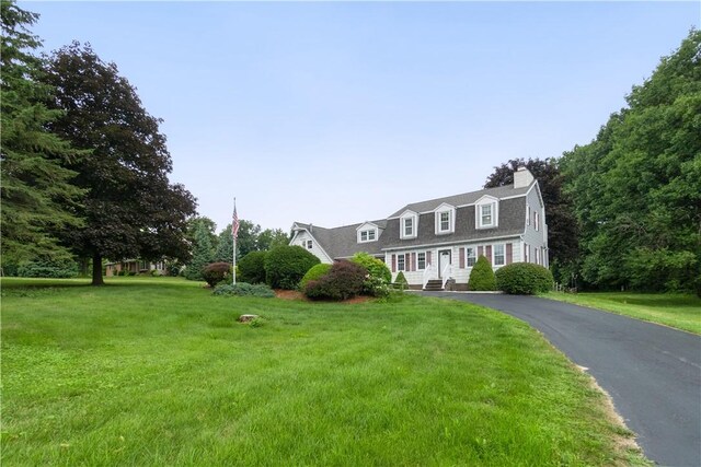 cape cod house with a front yard