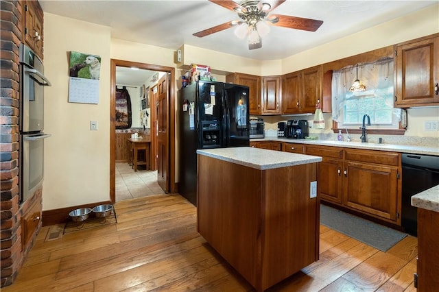 kitchen with light hardwood / wood-style flooring, dishwasher, a center island, ceiling fan, and sink