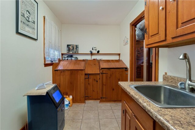 kitchen featuring sink and light tile patterned flooring