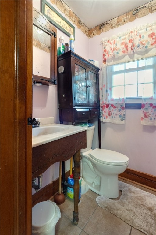 bathroom with tile patterned floors and toilet