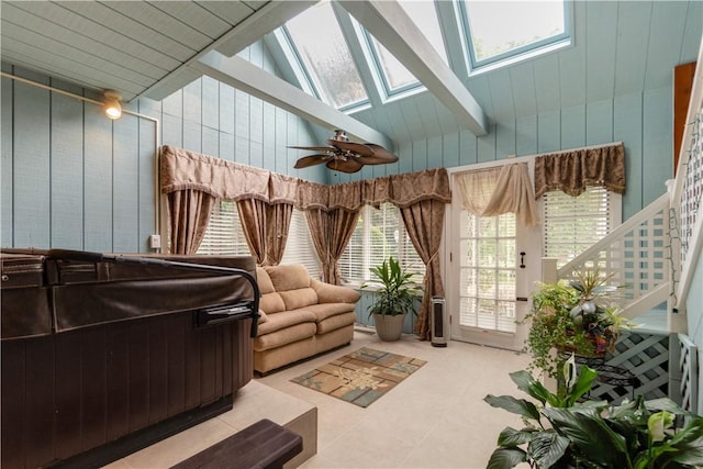 sunroom / solarium featuring ceiling fan and lofted ceiling with skylight