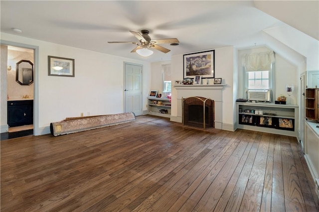 unfurnished living room with vaulted ceiling, cooling unit, dark wood-type flooring, and ceiling fan