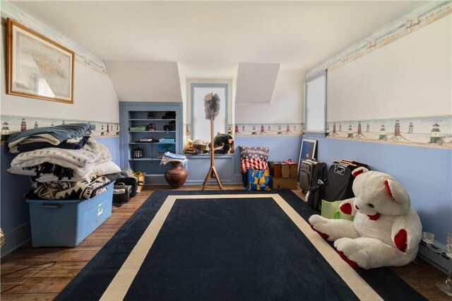 playroom featuring built in shelves and wood-type flooring