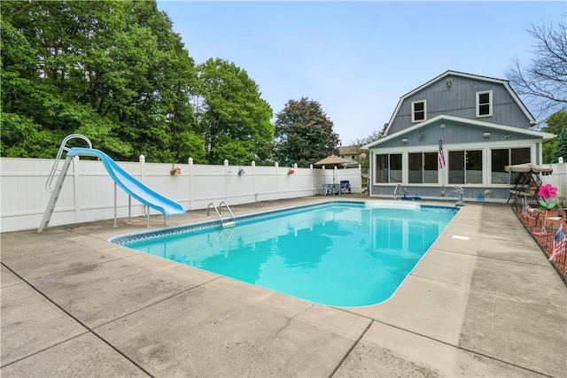 view of pool with a patio area and a water slide