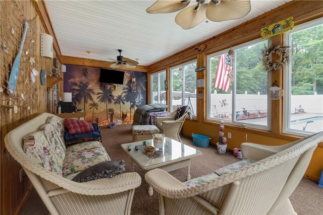 sunroom / solarium featuring ceiling fan