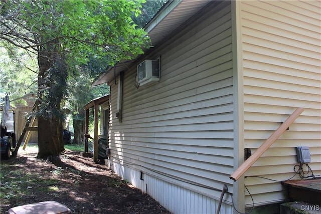 view of side of home featuring an AC wall unit