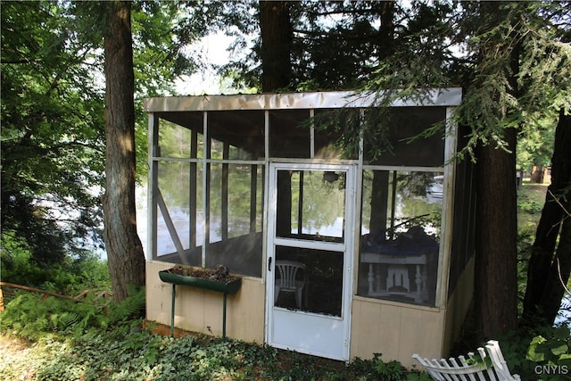 view of property exterior with a sunroom