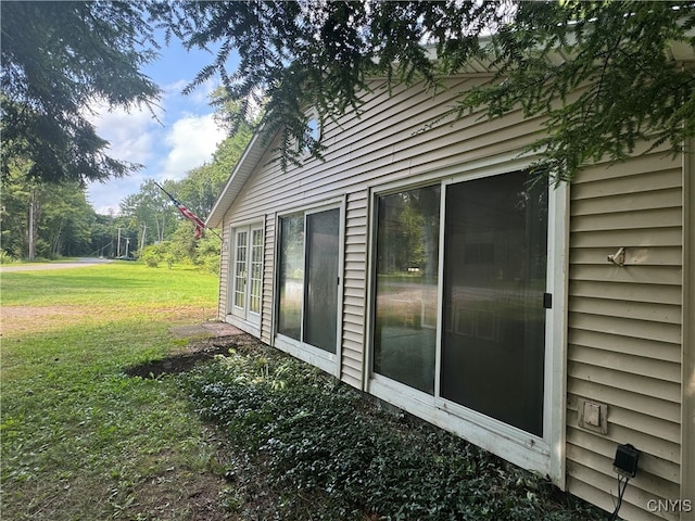 view of side of home featuring a yard