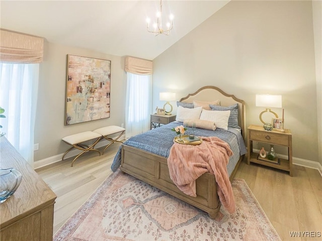 bedroom with lofted ceiling, a notable chandelier, baseboards, and wood finished floors