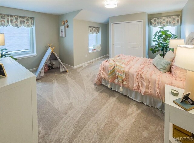 bedroom with carpet floors, a closet, and baseboards