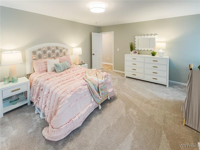 bedroom featuring baseboards and light colored carpet