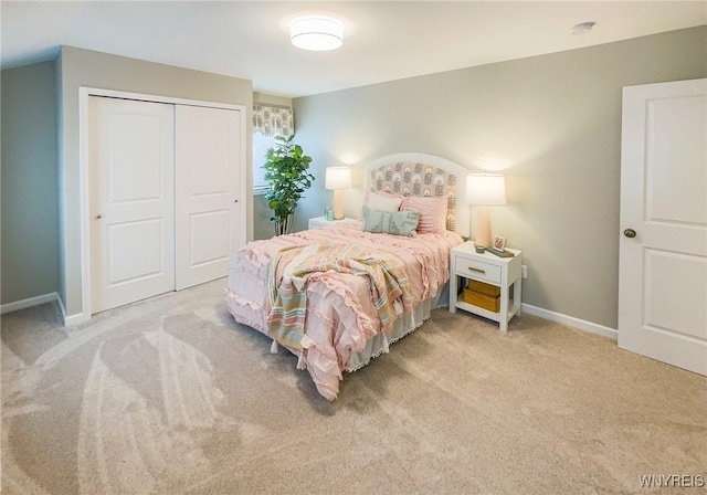 bedroom featuring light carpet and a closet