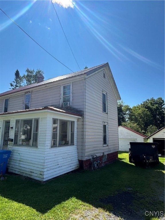 rear view of property with a yard