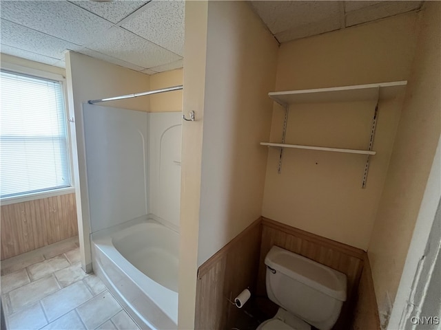 bathroom featuring toilet, a paneled ceiling, tile patterned flooring, and shower / bath combination