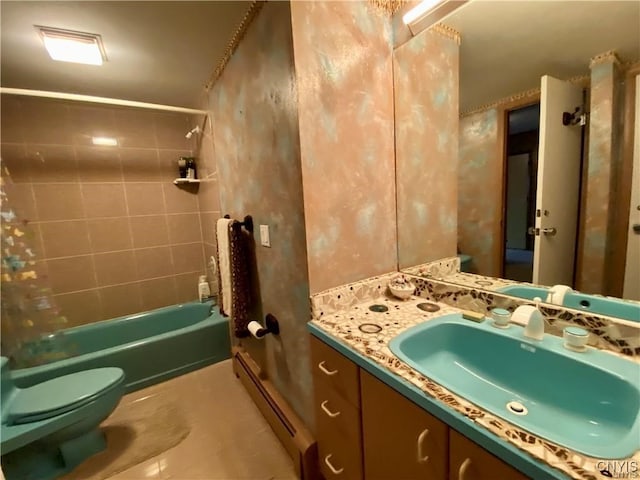 full bathroom with vanity, a baseboard radiator, tiled shower / bath combo, and toilet