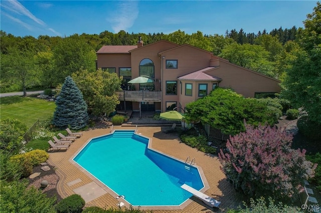 view of pool featuring a patio and a diving board