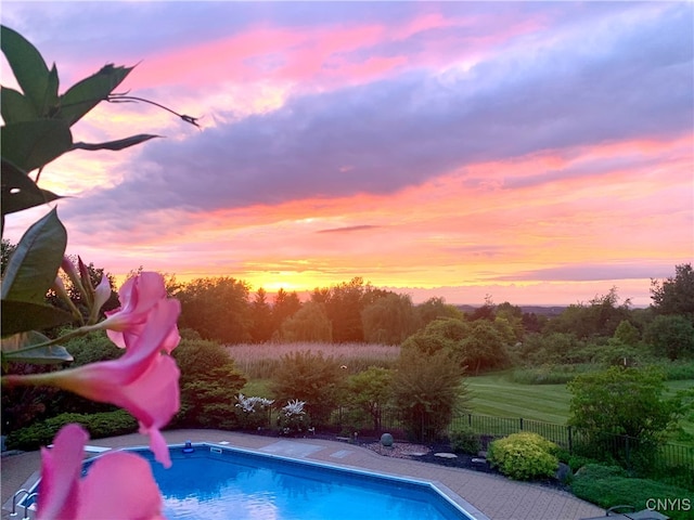 view of pool at dusk