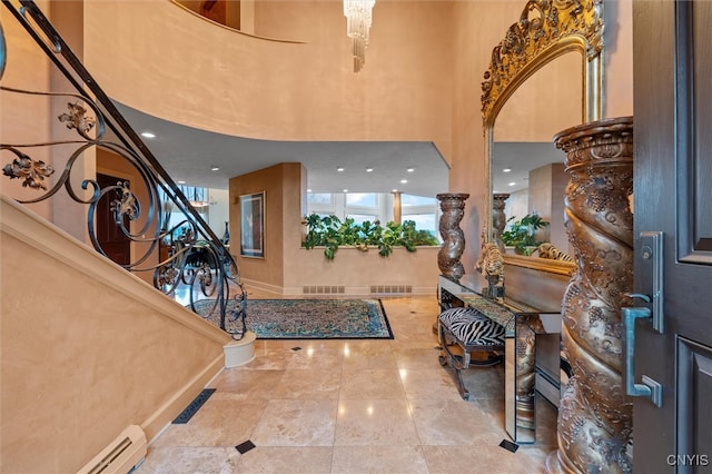 entryway with a towering ceiling and a baseboard radiator