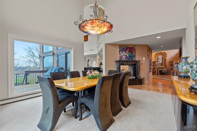 carpeted dining area with a high ceiling