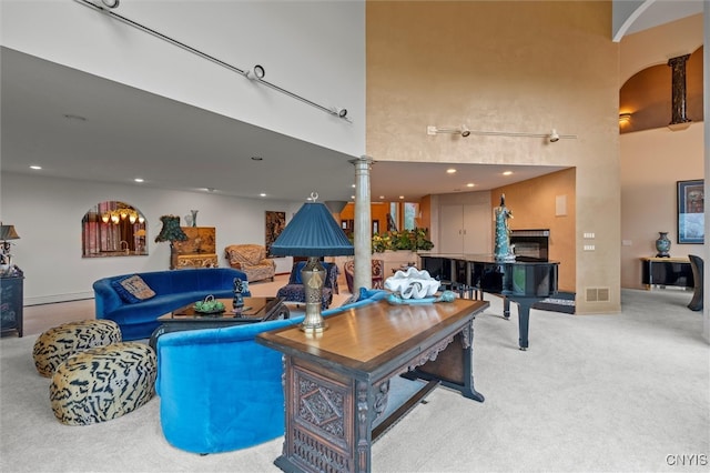 living room featuring ornate columns and carpet floors