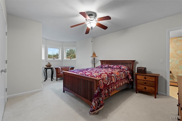 carpeted bedroom featuring baseboard heating and ceiling fan