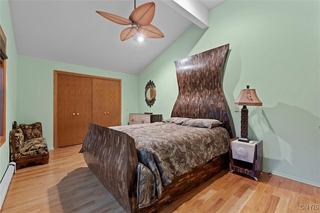 bedroom with ceiling fan, baseboard heating, vaulted ceiling with beams, light hardwood / wood-style floors, and a closet