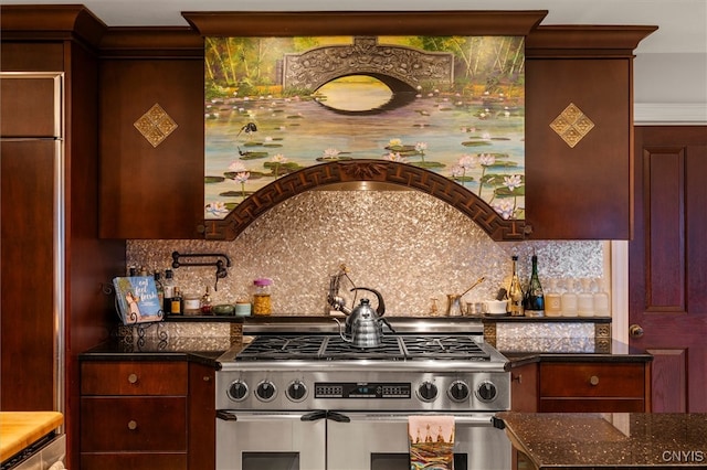 kitchen featuring backsplash, stainless steel stove, and dark stone counters