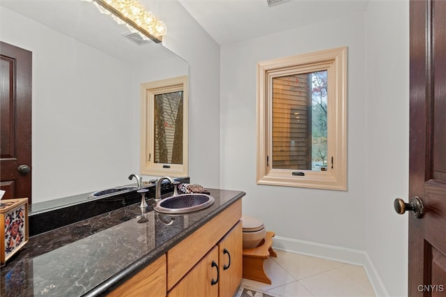 bathroom featuring tile patterned floors, vanity, and toilet