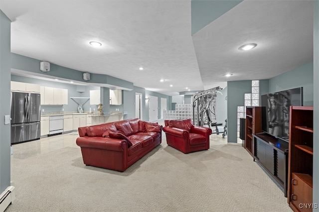 living room with baseboard heating, sink, light colored carpet, and a textured ceiling