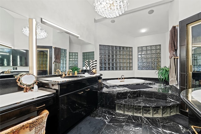 bathroom featuring tiled bath, vanity, high vaulted ceiling, and a chandelier