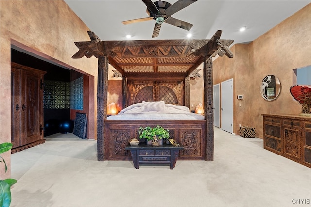 carpeted bedroom with high vaulted ceiling and ceiling fan