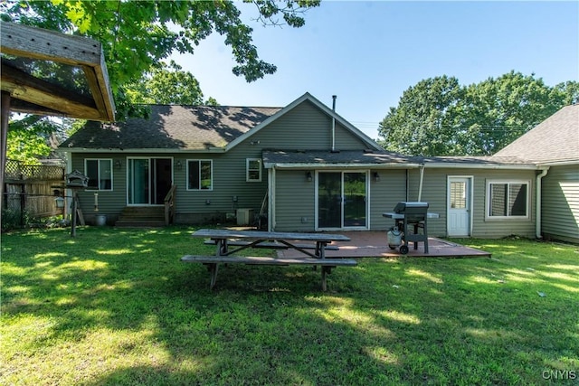 rear view of house featuring a lawn and a patio