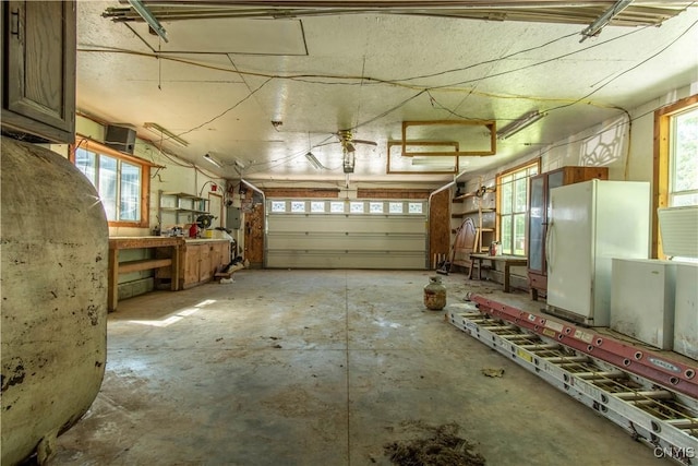 garage featuring a workshop area and white refrigerator