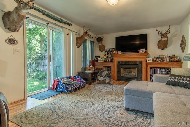 living room featuring a high end fireplace and hardwood / wood-style floors