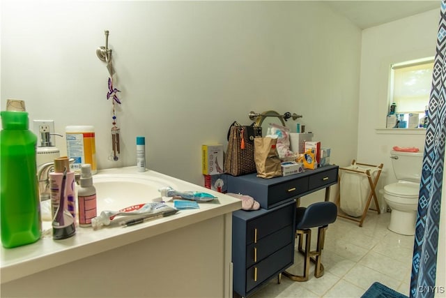 bathroom featuring vanity, tile patterned flooring, and toilet