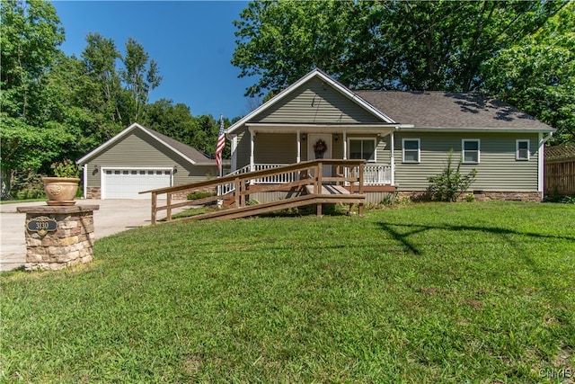 view of front facade with a front yard, covered porch, a garage, and an outdoor structure