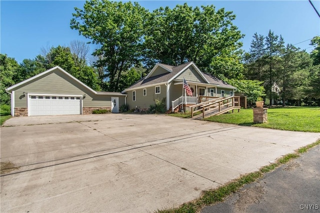 view of front facade with a garage, a front yard, and covered porch