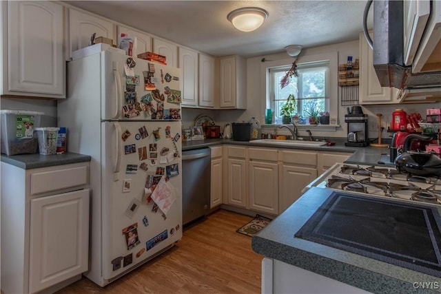 kitchen with sink, light wood-type flooring, white refrigerator, dishwasher, and white cabinets