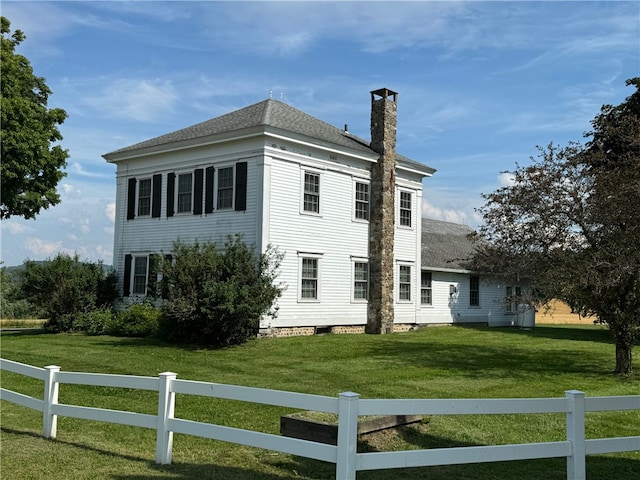 view of side of home featuring a yard