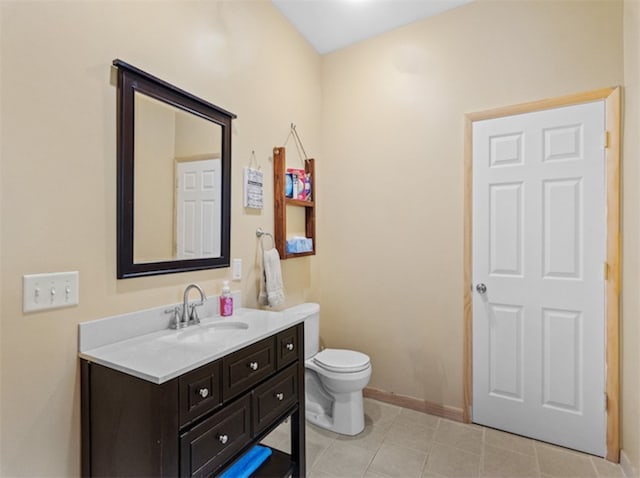 bathroom featuring toilet, tile patterned floors, and vanity