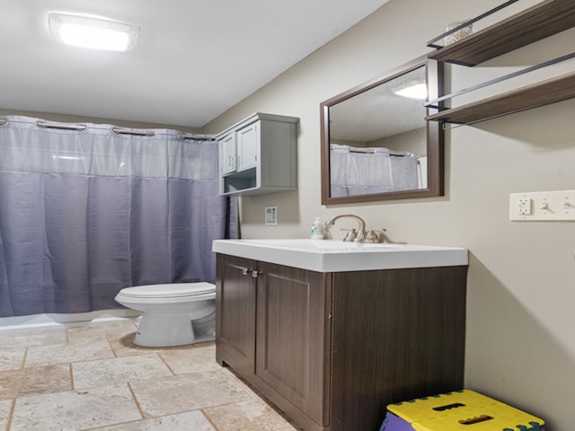 bathroom with toilet, tile patterned floors, and vanity