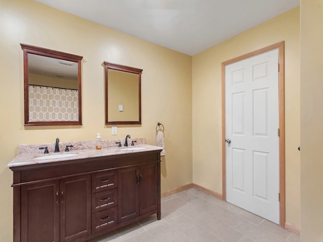 bathroom featuring tile patterned floors and double vanity