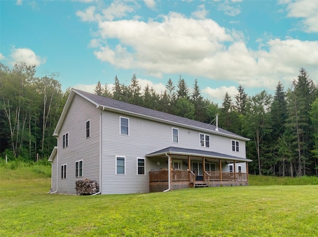 rear view of house with a porch and a lawn