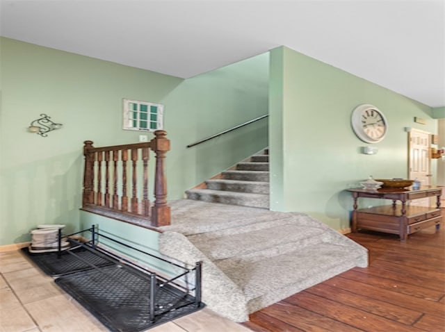 stairway featuring wood-type flooring