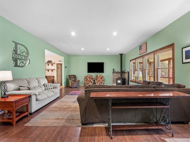 living room featuring a wood stove and hardwood / wood-style flooring