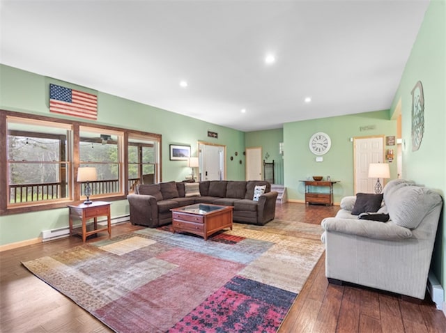 living room featuring a baseboard heating unit and hardwood / wood-style floors