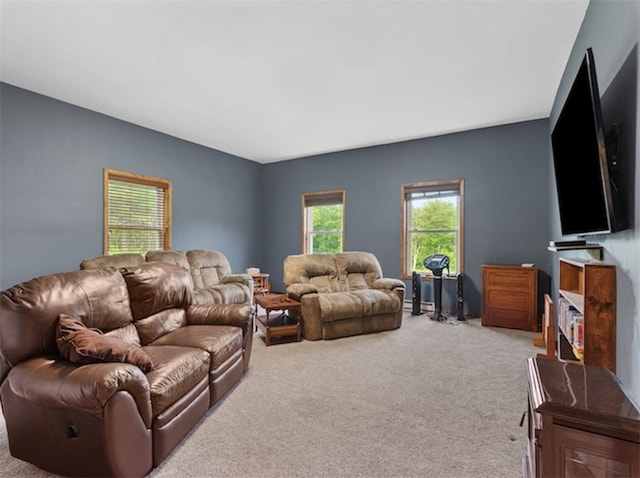 carpeted living room featuring baseboard heating