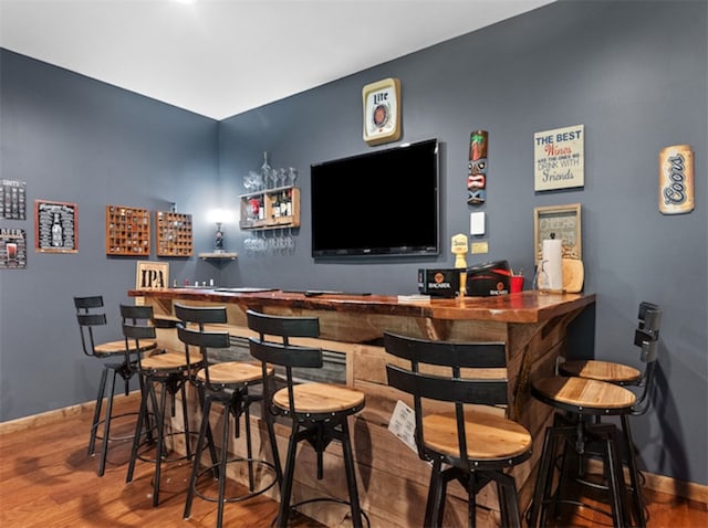 bar featuring hardwood / wood-style flooring