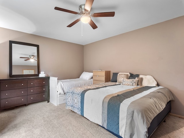 bedroom featuring ceiling fan and light carpet