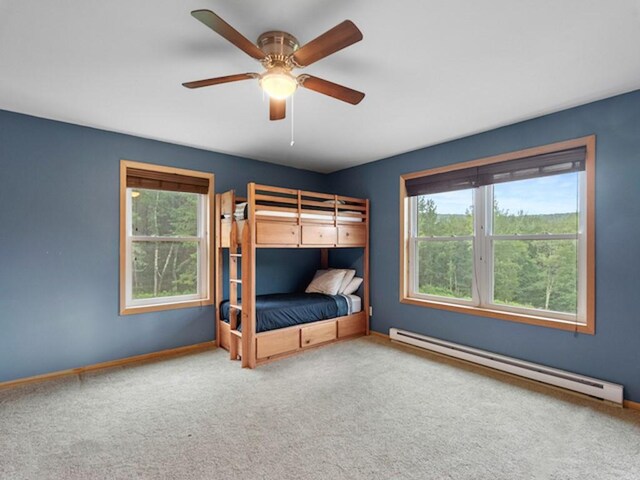1724 Calhoun Hill Rd, Andes, NY 13731 - unfurnished bedroom with a baseboard radiator, multiple windows, carpet flooring, and a ceiling fan